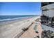 Expansive ocean view from a condo balcony, offering stunning beach scenery and a glimpse of the community amenities at 1210 N Waccamaw Dr. # 408, Garden City Beach, SC 29576