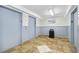 A well-lit hallway with neutral paint and tiled floor, featuring three elevator doors and classic decorative elements at 1210 N Waccamaw Dr. # 408, Garden City Beach, SC 29576
