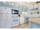 Efficient kitchen with white appliances, light blue cabinets and countertop at 1210 N Waccamaw Dr. # 408, Garden City Beach, SC 29576