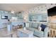 Open concept living room with ocean views, dining area, and adjacent kitchen with bar seating at 1210 N Waccamaw Dr. # 408, Garden City Beach, SC 29576