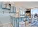Relaxing living area with kitchen breakfast bar access and ocean views through the balcony at 1210 N Waccamaw Dr. # 408, Garden City Beach, SC 29576