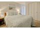 Bright bedroom with a comfortable bed, beach-themed art, and ample closet space at 1210 N Waccamaw Dr. # 408, Garden City Beach, SC 29576