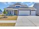 Charming home featuring a two-car garage, yellow door, and manicured lawn at 1279 Safe Haven Dr., Myrtle Beach, SC 29579