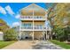 Inviting two-story yellow beach house with charming double balconies at 134 Vista Dr., Murrells Inlet, SC 29576