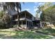 Exterior view of the home with a screened porch, patio, and well-maintained lawn at 135 Chapel Creek Rd. # 41, Pawleys Island, SC 29585