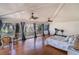 Bright bedroom featuring hardwood floors, ceiling fans, large windows, and a treadmill at 135 Chapel Creek Rd. # 41, Pawleys Island, SC 29585