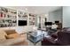 A cozy living room featuring built-in bookshelves, a comfortable couch, and a large window at 135 Chapel Creek Rd. # 41, Pawleys Island, SC 29585