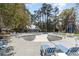 Community pool area surrounded by mature trees, lounge chairs, and a pool house at 135 Chapel Creek Rd. # 41, Pawleys Island, SC 29585