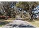 Scenic street view with mature, moss-draped trees lining the road leading to a home at 135 Chapel Creek Rd. # 41, Pawleys Island, SC 29585