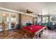 Comfortable sun room featuring terracotta tile flooring, exposed brick wall, and a full-sized pool table at 135 Chapel Creek Rd. # 41, Pawleys Island, SC 29585