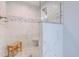 Beautiful bathroom showcases white marble tile, stylish mosaic accents, and a convenient built-in shower seat at 138 Cooper River Rd., Myrtle Beach, SC 29588