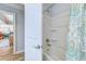 Bathroom featuring a bathtub with shower, complemented by a vibrant, patterned shower curtain at 138 Cooper River Rd., Myrtle Beach, SC 29588