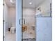 Modern bathroom features white marble tile, mosaic details, and a glass-enclosed shower with a wooden seat at 138 Cooper River Rd., Myrtle Beach, SC 29588