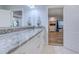Bathroom featuring granite counters, white cabinets, a large mirror, and a glimpse into the Primary bedroom at 138 Cooper River Rd., Myrtle Beach, SC 29588