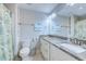 Bathroom view featuring toilet, white cabinets, granite counter, large mirror, and colorful shower curtain at 138 Cooper River Rd., Myrtle Beach, SC 29588
