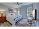 Cozy bedroom with a large bed, two windows, and a table with a rocking chair at 138 Cooper River Rd., Myrtle Beach, SC 29588
