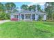 Charming one-story home with lush landscaping and inviting front porch at 138 Cooper River Rd., Myrtle Beach, SC 29588