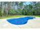 Private backyard pool with a lush green lawn and wooded views, ideal for relaxation at 138 Cooper River Rd., Myrtle Beach, SC 29588