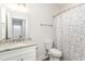 Clean bathroom features a granite vanity, white cabinets, toilet, and a shower with a decorative curtain at 1470 Burriss Rd., Conway, SC 29526