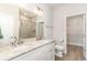 Bright bathroom with dual sinks, granite countertop, tile shower, and a door to the walk-in closet at 1470 Burriss Rd., Conway, SC 29526