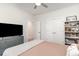 Cozy bedroom features a ceiling fan, TV, dresser, and a bookshelf with decorative items at 1470 Burriss Rd., Conway, SC 29526