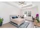 Bright bedroom with tray ceiling, ceiling fan, desk, exercise bike, and a window view to the neighborhood at 1470 Burriss Rd., Conway, SC 29526