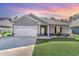 Charming one-story home with a well-manicured lawn, stone accents and a two car garage at 1470 Burriss Rd., Conway, SC 29526