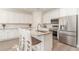 Bright kitchen features granite countertops, white cabinets, stainless steel appliances, and an island with bar seating at 1470 Burriss Rd., Conway, SC 29526