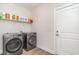 Modern laundry room with stainless steel washer and dryer, plus shelving for supplies at 1470 Burriss Rd., Conway, SC 29526