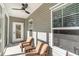 Covered porch features cozy seating, ceiling fan, and a view of the outdoors at 1470 Burriss Rd., Conway, SC 29526
