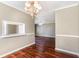 Cozy dining room featuring wood flooring, decorative lighting, and adjacent kitchen access at 1470 Turkey Ridge Dr. # D, Myrtle Beach, SC 29575