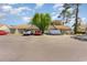 View of the townhome exteriors, with ample parking and mature trees at 1470 Turkey Ridge Dr. # D, Myrtle Beach, SC 29575