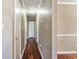 Hallway with hardwood flooring and white paneled doors at 1470 Turkey Ridge Dr. # D, Myrtle Beach, SC 29575