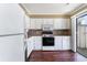 Well-lit kitchen featuring ample cabinet space, modern appliances, and a sliding glass door at 1470 Turkey Ridge Dr. # D, Myrtle Beach, SC 29575