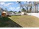 Spacious, manicured backyard featuring a privacy fence, deck with dining area, and a storage shed at 150 Brookgate Dr., Myrtle Beach, SC 29579