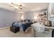 Bedroom with a ceiling fan, a large window, carpeted floor, lamps, and a rustic wood dresser at 150 Brookgate Dr., Myrtle Beach, SC 29579