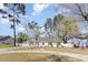 Charming single story home featuring a spacious front yard, rocking chair porch, and inviting curb appeal at 150 Brookgate Dr., Myrtle Beach, SC 29579