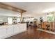 Open concept kitchen, dining and living room features wooden floors, large windows and ceiling fans at 150 Brookgate Dr., Myrtle Beach, SC 29579