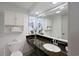 Bathroom features a granite countertop vanity with a modern sink and large mirror, plus storage shelves at 1501 S Ocean Blvd. # 1042, Myrtle Beach, SC 29577