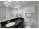 Bright bathroom features granite countertops, a modern sink, a large mirror, and coastal decor at 1501 S Ocean Blvd. # 1042, Myrtle Beach, SC 29577