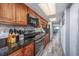 Galley kitchen features wood cabinets, granite countertops, and stainless appliances at 1501 S Ocean Blvd. # 1042, Myrtle Beach, SC 29577