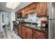 Well-equipped kitchen with wood cabinets, granite countertops, and stainless appliances at 1501 S Ocean Blvd. # 1042, Myrtle Beach, SC 29577