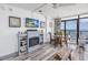 Open-plan living area with fireplace, dining set, TV, and ocean views at 1501 S Ocean Blvd. # 1042, Myrtle Beach, SC 29577
