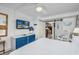 Comfortable bedroom with a king-size bed, TV, dresser, and rocking chair next to a sliding barn door at 1501 S Ocean Blvd. # 1042, Myrtle Beach, SC 29577