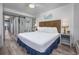 Comfortable bedroom with coastal decor, including a king-size bed, modern furnishings, and sliding door to the balcony at 1501 S Ocean Blvd. # 1042, Myrtle Beach, SC 29577