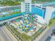Aerial shot of the resort's water park with colorful slides, palm trees, and playful design at 1501 S Ocean Blvd. # 1042, Myrtle Beach, SC 29577