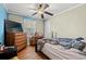 A primary bedroom features a ceiling fan, wood floors, and a window letting in lots of natural light at 1502 Mckeithan St., Conway, SC 29526