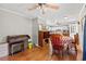 Open dining area with classic piano, view to the kitchen and plenty of seating for entertaining at 1502 Mckeithan St., Conway, SC 29526