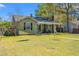 View of the home from the yard featuring a well-kept lawn and inviting front porch at 1502 Mckeithan St., Conway, SC 29526