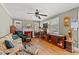Inviting living room featuring a decorative fireplace, ceiling fan, and vintage furnishings at 1502 Mckeithan St., Conway, SC 29526